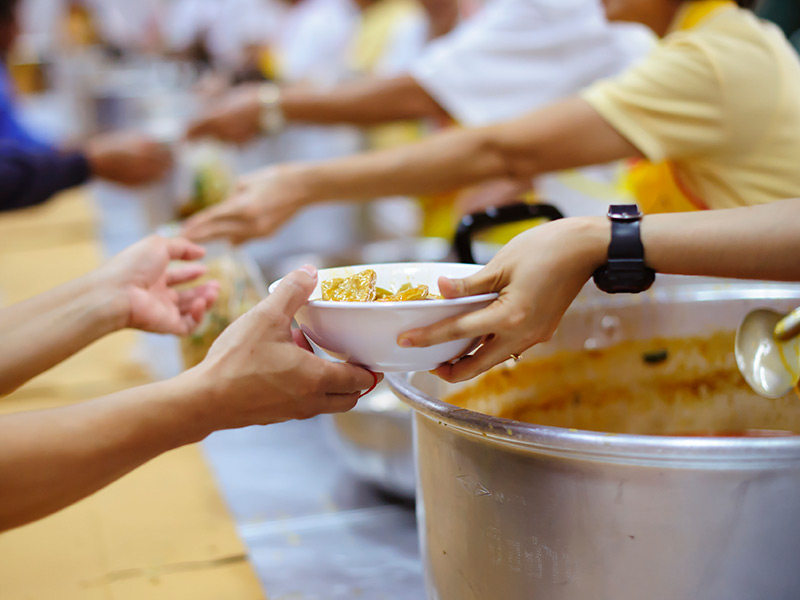 Charity workers handing out bowls of food